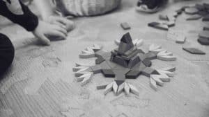 play is learning - image shows students working with puzzle blocks collaboratively